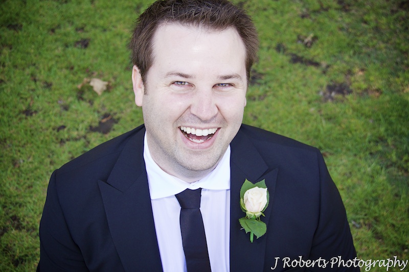 Groom laughing up at the camera - wedding photography sydney